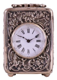 France, small carriage clock, the silver case with repousse ornament in the rococo style, Roman numeral white enamel dial, blued steel hands, 8 day timepiece movement with lever platform