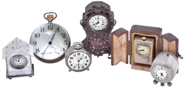 Clocks- 6 (Six): including a miniature carriage clock with outer case, a "Tip Top Traveler", two mother of pearl clad miniatures, one barrel form, a silver repousse miniature in the rococo style, and a Waltham paperweight clock