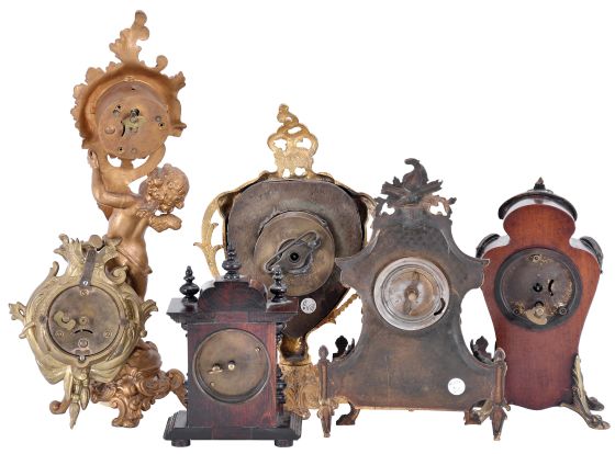 Clocks- 6 (Six): including an Ansonia figural with putto, an Ansonia cartel style, a Hamburg - American with gilt brass case set with porcelain panel featuring putti, a British United with gilt brass case, and two wooden miniatures