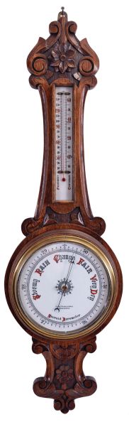 Barometers- 2 (Two) English: (1) Lloyd, Payne & Amiel, Manchester, aneroid barometer with alcohol thermometer with red accented scales in a carved oak case with floral design; (2) Chapman, Lewes, banjo or wheel mercury barometer with thermometer, hygrometer, and spirit level in a rosewood veneered case.