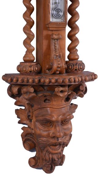 T. Boxell, Brighton, an ornately carved softwood barometer, the base with "green man" mask, trimmed with foliate ornament, beneath a shelf with barley twist columns flanking a thermometer with engraved reamur and fahrenheit scales, the top with engraved barometer scales surrounded by carved trim, and surmounted with a large, removable top carved with scallop shell, fruit and leaves