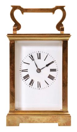 France, carriage clock, 8 day, time and strike, spring-driven movement with a lever escapement in an polished brass Anglaise case with five beveled glasses, white enamel dial, and blued steel hands, all in a leather carrying case.