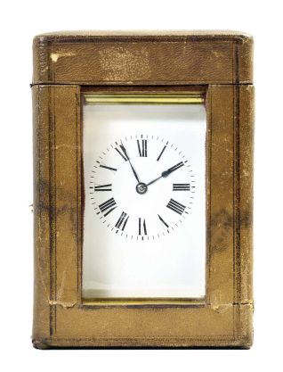 France, carriage clock, 8 day, time and strike, spring-driven movement with a lever escapement in an polished brass Anglaise case with five beveled glasses, white enamel dial, and blued steel hands, all in a leather carrying case.