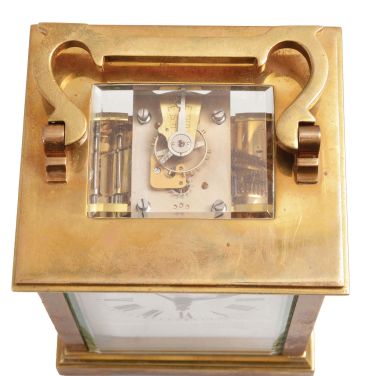 France, carriage clock, 8 day, time and strike, spring-driven movement with a lever escapement in an polished brass Anglaise case with five beveled glasses, white enamel dial, and blued steel hands, all in a leather carrying case.