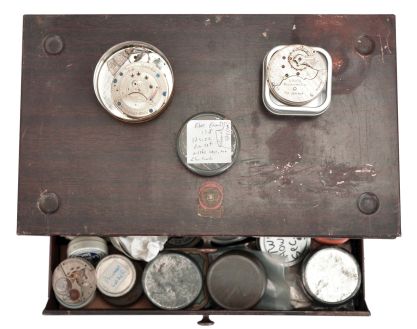 Two drawer cabinet filled with American pocket watch movements, makers including South Bend, Waltham, Elgin, Philadelphia, Rockford, Hampden, and Illinois