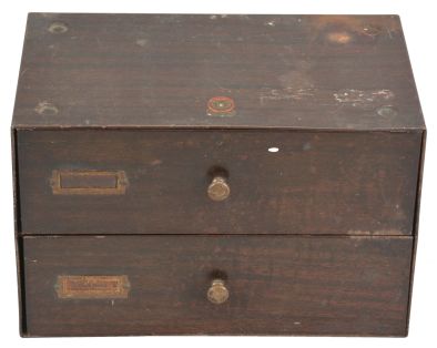 Two drawer cabinet filled with American pocket watch movements, makers including South Bend, Waltham, Elgin, Philadelphia, Rockford, Hampden, and Illinois