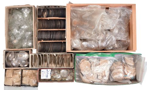 Wrist and pocket watch parts, three large boxes filled with material assortments from various manufacturers, including jewels, staffs, stems, crowns, gaskets, and more, for both Swiss and American watches, together with a box and a metal cabinet each containing hundreds of pocket watch crystals, and a wood pocket watch display case with glass door.