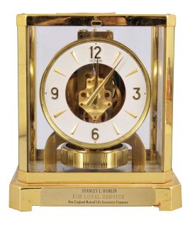 Jaeger-LeCoultre, Switzerland, "Atmos" clock, 15 jewel, caliber 528-8/6 movement, torsion pendulum, round metal dial with applied gilt arrow markers and numbers, gilt hands, all contained in a glazed rectangular case with original styrofoam packaging box, serial #220770.