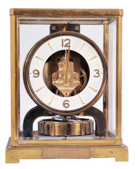 Jaeger-LeCoultre, Switzerland, "Atmos" clock, 15 jewel, caliber 526-5 movement, torsion pendulum movement with round metal dial, applied gilt arrow markers and numbers, gilt hands, in a glazed rectangular case with hinged font door, original cloth-covered box, serial #106500.