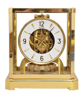 Jaeger- LeCoultre, Switzerland, "Atmos" clock, 15 jewel movement, gilt torsion pendulum, square white painted dial with applied gilt Arabic numerals and arrow markers, gilt hands, all contained in a glazed rectangular case with removable front panel, serial #296852, c1983.