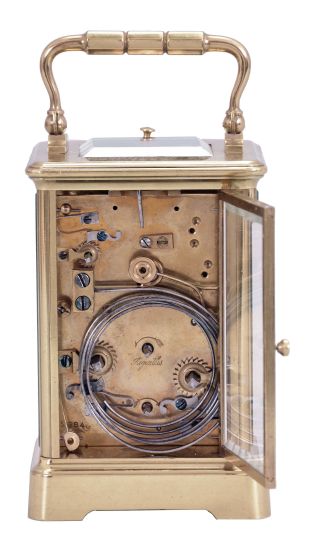 France, a petite sonnerie striking carriage clock with grand sonnerie repeating, polished brass Corniche case with bevelled glasses, the top engraved "J. K. Connally, Oct. 7, 1897", Roman numeral white enamel dial with gilt mask and subsidiary alarm dial, blued steel hands, 8 day, time, strike and alarm movement with lever platform, sounding the quarters in passing, and repeating the last hour and quarter on demand