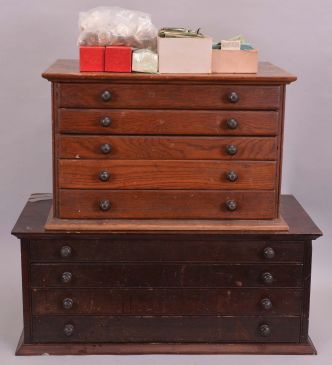 2 (Two) Cabinets of Watch Crystals: one four drawer wood cabinet and one five drawer wood cabinet, both with many pocket and wrist watch crystals. Lot also includes a partial box of crystals.