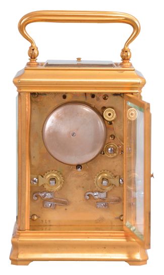 France, for Bailey, Banks, and Biddle, Philadelphia, a gilt, Cannelee variant cased hour repeating carriage clock, the glazed case with molded base and cornice, top with carrying handle, Roman numeral white enamel dial, blued steel spade hands, 8 day, two train movement with lever platform, striking the hours and half hour in passing, and repeating the last hour on demand