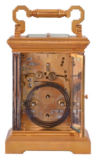 France, for George C. Shreve & Co., San Francisco, a gilt and silvered, hour repeating carriage clock, the architectural case with stepped, molded base and cornice, five beveled glasses, roman numeral gilt dial with Arabic alarm chapter, blued steel distaff hands, 8 day, three train movement with lever platform, striking the hour and half hour in passing, and repeating the last hour on demand