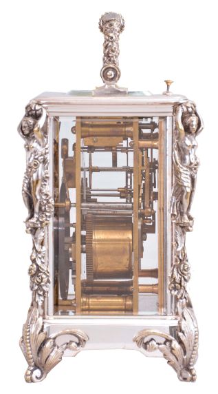 France, a silvered, Caryatides cased hour repeating carriage clock, the case with foliate ornamented scroll feet, the corners with floral drops supporting female figures, and handle with floral and foliate ornament, roman numeral silvered dial, blued steel spade hands, 8 day, two train movement with lever platform, striking the hours and half hour in passing, and repeating the last hour on demand