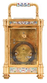 France, an unusual, champlevé enamel decorated, pillars style hour repeating carriage clock, the gilt case with outset corners, turned feet and columns, the base, frieze, and top with scrolling foliate designs, and decorated with polychrome enamel colors on a turquoise ground, the front of base with engraved presentation "Sir Donald Currie, K.C.M.G., M.P. In Remembrance of a Pleasant Cruise in the Pembroke Castle, Septr. 1883, from J.C.", Arabic numeral champlevé enamel dial with fine engraving and matching the exterior colors, blued steel distaff hands, two train movement with lever platform, striking the hours and half hour in passing, and repeating the last hour on demand