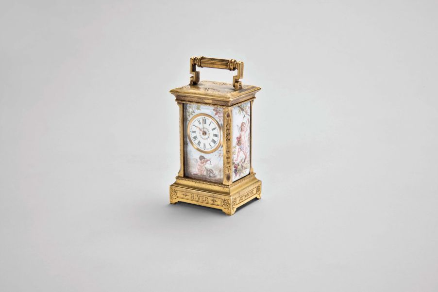 Switzerland, an exceptional miniature carriage clock with enameled panels, the engraved, gilt case nearly 3/4 inches smaller than a mignonette No.1, the sides and back with polychrome enamel scenes of disporting putti, the Roman numeral enamel dial with mask matching the exterior panels, each representing one of the four seasons, the base with engraved titles, "Hiver, Automne, Printemps, Ete", 30 hour, timepiece movement with cylinder escapement, and fabric covered travel case with key