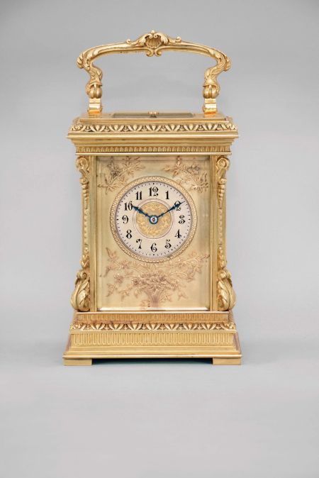 France, a highly ornamental and well executed hour repeating carriage clock, the gilt, Anglaise Riche variant case with stepped base below a fluted band and egg and dart molded surface canted corners ornamented with acanthus scroll bases and E scroll tops, supporting an entablature echoing the base, with fluted band, stepped cornice, and egg and dart cap, the top with folding handle decorated with acanthus and central scallop shell, all decorative ornament with fine chasing, Arabic numeral silvered dial with blued steel distaff hands, and gilt mat with applied, gilt floral ornaments, also finely chased, 8 day, two train movement with lever platform and cut bimetallic balance, striking the hour and half hour in passing, and repeating the last hour on demand