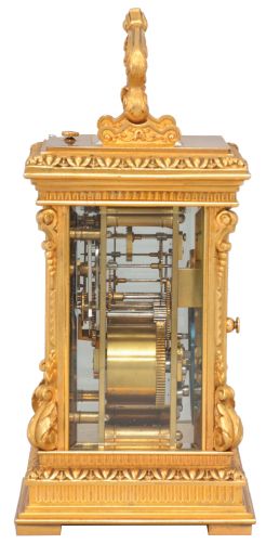 France, a highly ornamental and well executed hour repeating carriage clock, the gilt, Anglaise Riche variant case with stepped base below a fluted band and egg and dart molded surface canted corners ornamented with acanthus scroll bases and E scroll tops, supporting an entablature echoing the base, with fluted band, stepped cornice, and egg and dart cap, the top with folding handle decorated with acanthus and central scallop shell, all decorative ornament with fine chasing, Arabic numeral silvered dial with blued steel distaff hands, and gilt mat with applied, gilt floral ornaments, also finely chased, 8 day, two train movement with lever platform and cut bimetallic balance, striking the hour and half hour in passing, and repeating the last hour on demand