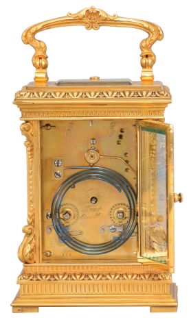 France, a highly ornamental and well executed hour repeating carriage clock, the gilt, Anglaise Riche variant case with stepped base below a fluted band and egg and dart molded surface canted corners ornamented with acanthus scroll bases and E scroll tops, supporting an entablature echoing the base, with fluted band, stepped cornice, and egg and dart cap, the top with folding handle decorated with acanthus and central scallop shell, all decorative ornament with fine chasing, Arabic numeral silvered dial with blued steel distaff hands, and gilt mat with applied, gilt floral ornaments, also finely chased, 8 day, two train movement with lever platform and cut bimetallic balance, striking the hour and half hour in passing, and repeating the last hour on demand