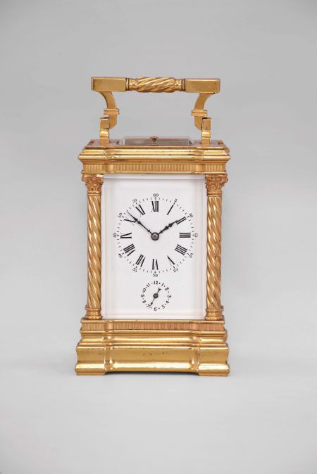 France, a good hour repeating, Anglaise Riche variant carriage clock with alarm, the gilt case with molded base and fluted band supporting twisted columns with Corinthian capitals, the entablature with fluted band, and stepped, molded cornice, case top with folding handle, roman numeral white enamel dial, blued steel distaff hands, three train movement with lever platform, sounding the hour and half hour in passing, and repeating the last hour on demand