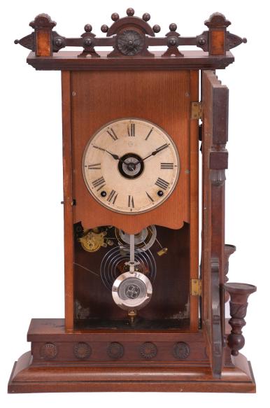 Seth Thomas Clock Co., Thomaston, Conn., "Beloit" shelf clock with a spring driven, 8 day, time, strike and alarm movement in a walnut case with burl accents.