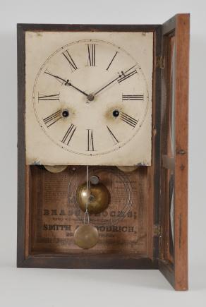 Smith & Goodrich, Bristol, Conn., box shelf clock, 30 hour, time and strike, spring driven brass movement with wooden fusees in a mahogany veneered case with painted metal dial and blued steel club hands.