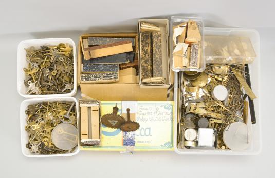 Parts- 6 (Six) boxes of clock parts including many mainsprings, dozens of keys, verges, cables & cord, fasteners, clock oil, wall hooks, gongs, many antique cast metal case parts, and more, together with a group of American and Swiss watch movements, crowns, and wrist watches.