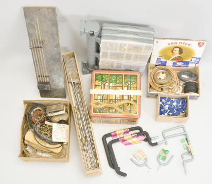 Parts- 6 (Six) boxes of clock parts including many mainsprings, dozens of keys, verges, cables & cord, fasteners, clock oil, wall hooks, gongs, many antique cast metal case parts, and more, together with a group of American and Swiss watch movements, crowns, and wrist watches.