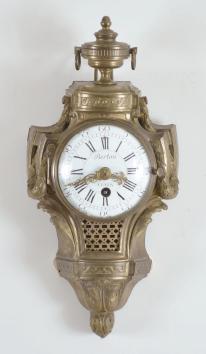 Clocks- 2 (Two) miniature wall: (1) A.D. Mougin, Paris, France, and Edouard Serin, France for Berton, Paris, cartel clock, 8 day, time only, spring driven movement in a cast brass case with urn finial, roman numeral white enamel dial with pierced gilt hands, c1880; (2) Probably Austrian, miniature wall clock, 2 day, time only, spring driven movement with silk thread suspension in a drop dial case with "H. Norton / London" painted on the lower portion, roman numeral white enamel dial and brass hands.