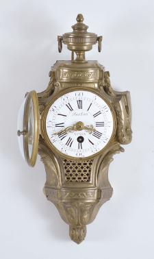 Clocks- 2 (Two) miniature wall: (1) A.D. Mougin, Paris, France, and Edouard Serin, France for Berton, Paris, cartel clock, 8 day, time only, spring driven movement in a cast brass case with urn finial, roman numeral white enamel dial with pierced gilt hands, c1880; (2) Probably Austrian, miniature wall clock, 2 day, time only, spring driven movement with silk thread suspension in a drop dial case with "H. Norton / London" painted on the lower portion, roman numeral white enamel dial and brass hands.