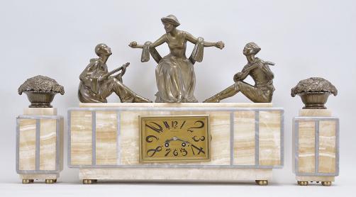 Clocks- 2 (Two) French: (1) France, for Brunott Juwelier, Rotterdam, Netherlands, three piece mantel garniture, 8 day, time and strike, spring driven pendule de Paris movement in an Art Deco case made of white onyx and gray marble, topped with the patinated figure of a woman with outstretched arms flanked by seated musicians on either side, gold painted metal dial, stylized arabic numerals and black steel hands, with two matching side pieces, c1920; (2) France, figural mantel clock, 8 day, time and strike, spring driven pendule de Paris movement in an Art Deco case made of white onyx, black slate, and variegated roseate marble, topped with two large cast German Shepard dog figures, silver colored metal dial with stylized arabic numerals and black steel hands, c1925.