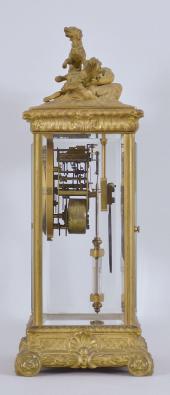 Seth Thomas Clock Co., Thomaston, Conn., "Empire No. 14" crystal regulator, 8 day, time and strike, spring driven brass movement in a gilt case with cast hunting scene at top, beveled glasses on all four sides, arabic numeral white enamel dial, blued steel hands, with simulated mercury pendulum.