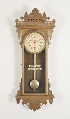 Clocks- 2 (Two): (1) E.N. Welch Manufacturing Co., Forestville, Conn., "Eclipse" wall clock, 8 day, time only with simple calendar, spring driven brass movement in a walnut case with papered metal dial, c1889; (2) Lenzkirch AG, Lenzkirch, Germany, wall clock or "RA" clock, 8 day, time only, spring driven movement in a mahogany veneer case, two-piece roman numeral white enamel dial with black steel hands, c1882.