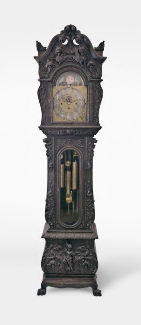 J.J. Elliott, London, England, monumental tall clock, 8 day, time, strike and chime movement playing Westminster or Whittington quarters on nine tubular bells, in an extremely ornate, carved oak case featuring gargoyles and other mythical creatures. The brass dial is nicely shaped and has raised silver chapter ring and subsidiary seconds, all surrounded by ornately cast brass trim and spandrels with cast brass dial center