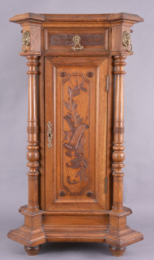 The Gramophone & Typewriter Ltd., 21 City Rd, Finsbury Square, London, England, the English subsidiary of Victor Talking Machine Co., "Type D" oak cased phonograph with original 21" diameter oak horn, 21" resting on an oak and quarter sawn oak record cabinet with single drawer over a single cabinet flanked by full turned columns flanking panels with carved musical trophies. Includes three albums of records.