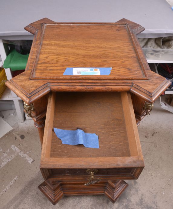 The Gramophone & Typewriter Ltd., 21 City Rd, Finsbury Square, London, England, the English subsidiary of Victor Talking Machine Co., "Type D" oak cased phonograph with original 21" diameter oak horn, 21" resting on an oak and quarter sawn oak record cabinet with single drawer over a single cabinet flanked by full turned columns flanking panels with carved musical trophies. Includes three albums of records.