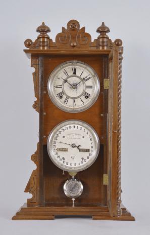 Waterbury Clock Co., Waterbury, Conn., "Calendar No. 40" shelf clock with a spring driven 8 day time and strike movement and an Albert F. Wells patented perpetual calendar mechanism in a walnut case.