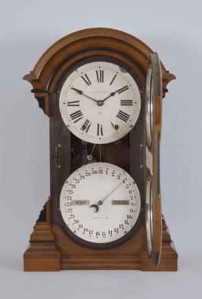 Seth Thomas Clock Co., Thomaston, Conn., "Parlor Calendar No. 4" with a spring driven 8 day time and strike movement with a R. T. Andrews patented perpetual calendar mechanism in a walnut case.