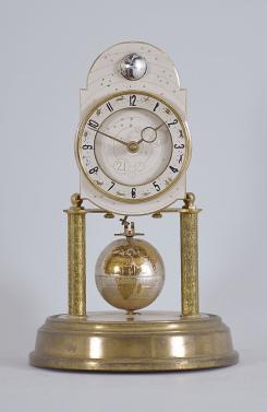 J. Kaiser GmbH, Villingen, Germany, "Universe" 400-day clock, year running, time and moon phase, spring driven brass movement with metallic globe torsion pendulum, monochrome zodiac dial, silver chapter with polished brass numerals, brass hands, all under a glass dome.