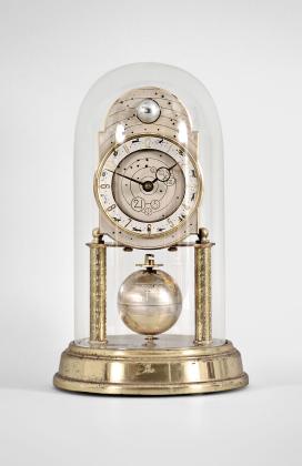 J. Kaiser GmbH, Villingen, Germany, "Universe" 400-day clock, year running, spring driven brass movement with metallic rotating globe torsion pendulum and moon phase dial, monochrome zodiac dial, white chapter with polished brass numerals, brass hands, all under a glass dome.