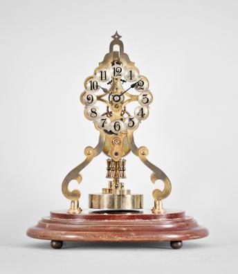 Gustav Becker, Germany, skeleton form 400 day clock, year running, spring driven brass movement with torsion pendulum and deadbeat escapement, pierced brass plates, silvered arabic numeral dial and blued steel spade hands, brass disc pendulum, all mounted to an oval wooden base