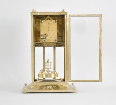 Jahresuhrenfabrik, Triberg, Germany, "Model No. 235"400-day clock, year running, time only, spring driven brass movement with torsion pendulum in an Art Nouveau style brass case with glazed front, sides, and back, brass dial with stylized arabic numerals, black steel hands, and disc pendulum.