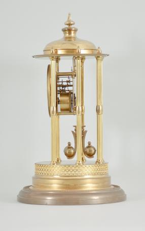 Kienzle GmbH, Schwenningen, Germany, Louvre style 400-day clock, year running, time only, spring driven torsion pendulum movement in a polished brass case with six fluted columns, arabic numeral arcaded enamel dial, all under a glass dome.