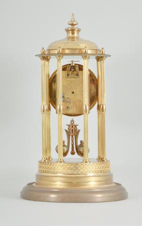 Kienzle GmbH, Schwenningen, Germany, Louvre style 400-day clock, year running, time only, spring driven torsion pendulum movement in a polished brass case with six fluted columns, arabic numeral arcaded enamel dial, all under a glass dome.