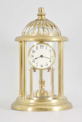 Kienzle GmbH, Schwenningen, Germany, Louvre style 400-day clock, year running, time only, spring driven movement with torsion pendulum and gimbaled suspension mount in a polished brass case with five columns, arabic numeral white enamel dial, all under a glass dome fitted inside of the columns and capped with a pierced dome.