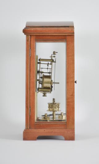 Gustav Becker, Freiburg, Germany for B.H. Abrahams, London, 400-day clock, year running, time only, spring driven brass movement with torsion pendulum in a glazed hardwood case with arch top, arabic numeral silvered dial, and black steel spade hands.

