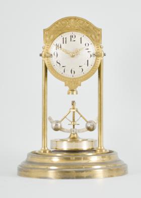 Gebrüder Junghans AG, Schramberg, Germany, 400 day clock, year running, time only, spring driven brass movement with torsion pendulum and deadbeat escapement with Vulliamy pallets, brass base and pillars supporting the movement and convex silvered dial with embossed brass mask, ornate Louis XV style hands, all under a glass dome.