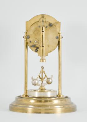 Gebrüder Junghans AG, Schramberg, Germany, 400 day clock, year running, time only, spring driven brass movement with torsion pendulum and deadbeat escapement with Vulliamy pallets, brass base and pillars supporting the movement and convex silvered dial with embossed brass mask, ornate Louis XV style hands, all under a glass dome.