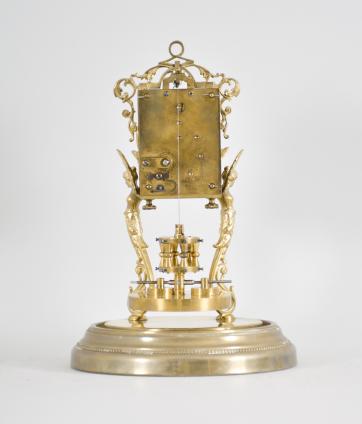 Attributed to Andreas Huber, Munich Germany or Jahresuhrenfabrik, Triberg, Germany, 400 day clock, year running, time only, spring driven movement with torsion pendulum on a brass base with gilt cast caryatid figures supporting the movement, arabic numeral cream enamel dial with black spade hands, all under a glass dome.